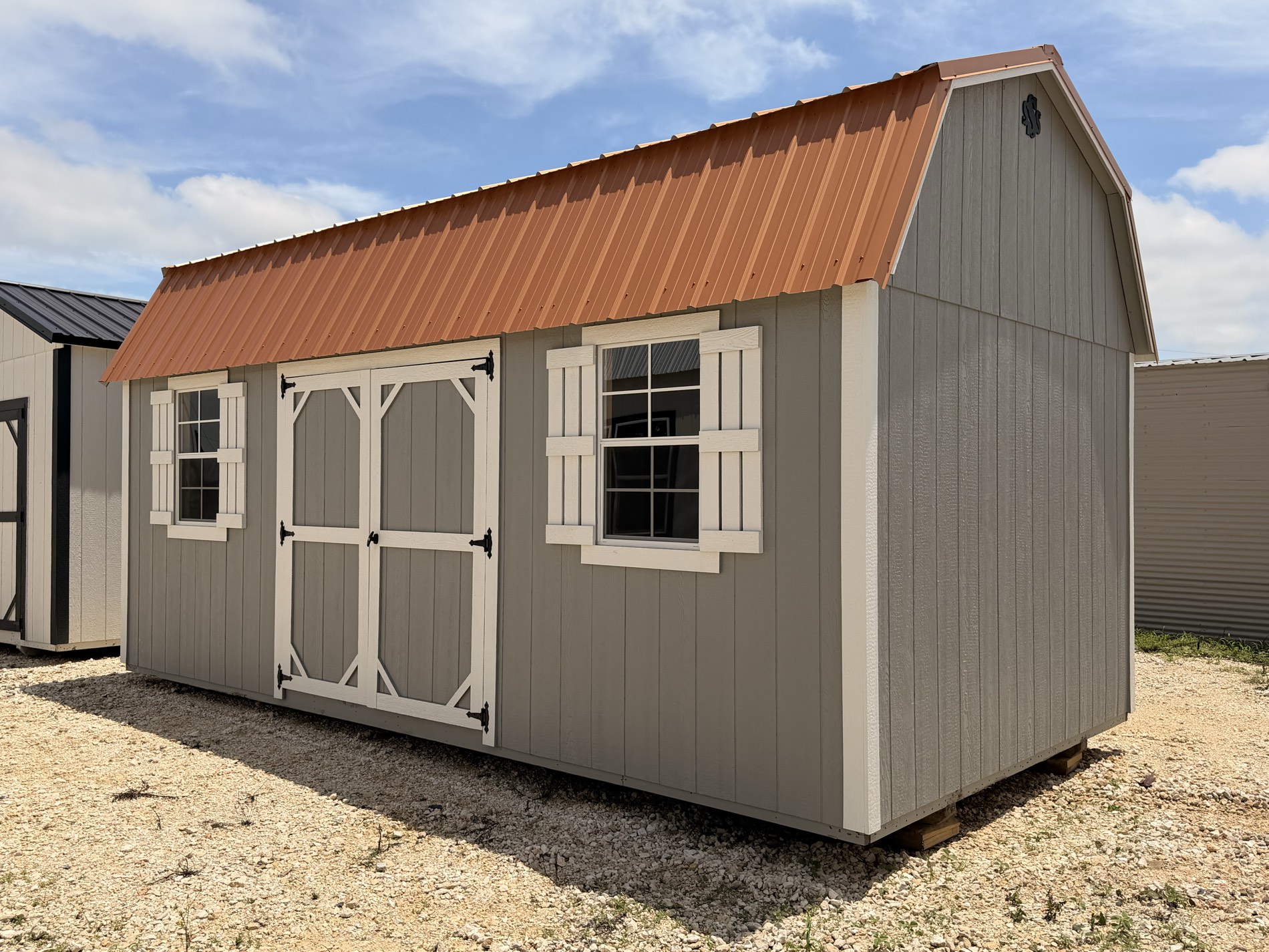 A lofted barn with a copper roof on the Secure Storage Sheds of Jarrell lot